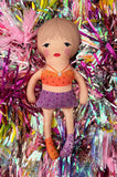 the 1989 doll in orange and purple